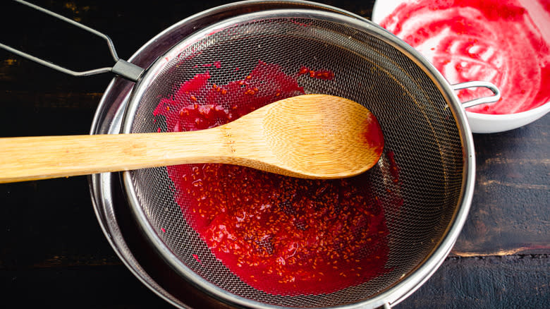 Straining seeds from fruit purée