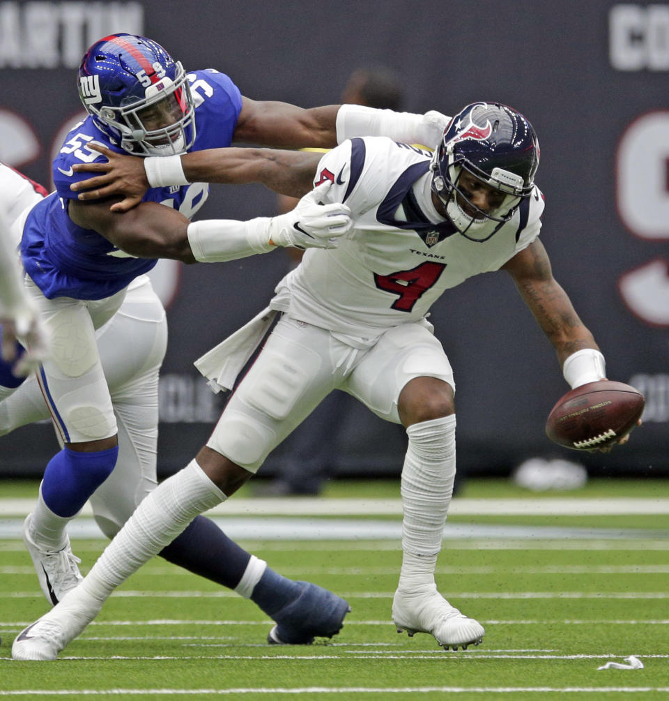 New York Giants linebacker Lorenzo Carter (59) reaches to tackle Houston Texans quarterback Deshaun Watson (4) during the first half of an NFL football game Sunday, Sept. 23, 2018, in Houston. (AP Photo/Michael Wyke)