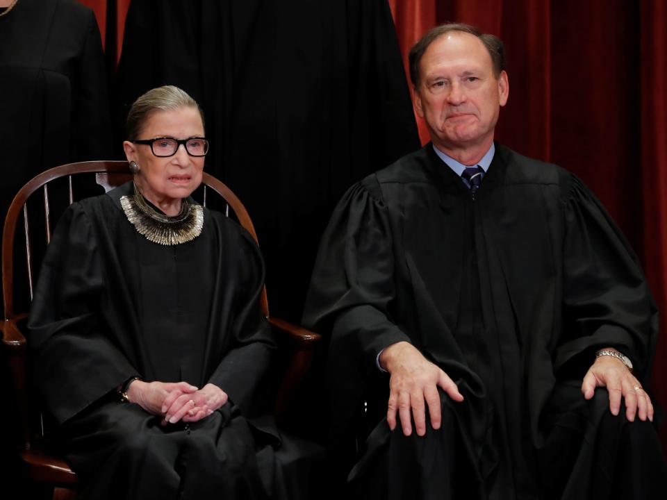 U.S. Supreme Court Associate Justices Ruth Bader Ginsburg and Samuel Alito, Jr. sit next to each other as all of the justices on the court pose for their group portrait on November 30, 2018.