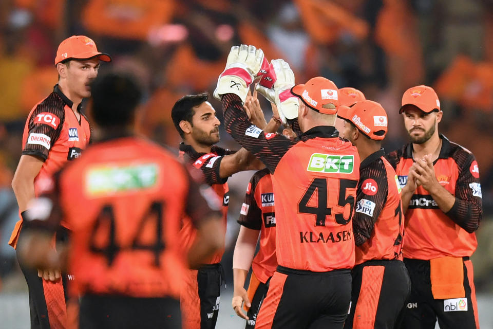 Sunrisers Hyderabad's Bhuvneshwar Kumar (C) celebrates with teammates after taking the wicket of Punjab Kings' Prabhsimran Singh (not pictured) during the Indian Premier League (IPL) Twenty20 cricket match between Sunrisers Hyderabad and Punjab Kings at the Rajiv Gandhi International Cricket Stadium in Hyderabad on April 9, 2023. (Photo by Noah SEELAM / AFP) (Photo by NOAH SEELAM/AFP via Getty Images)