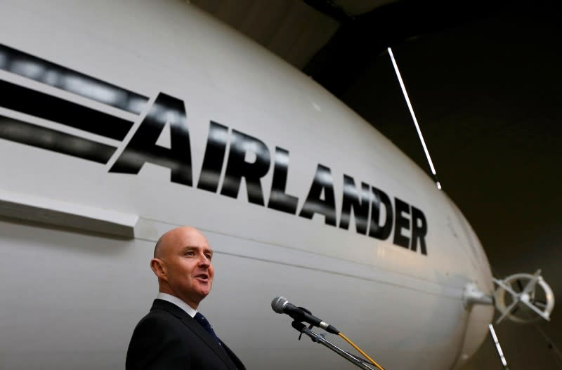 Hybrid Air Vehicles CEO Stephen McGlennan speaks besides the Airlander 10 hybrid airship during its unveiling in Cardington