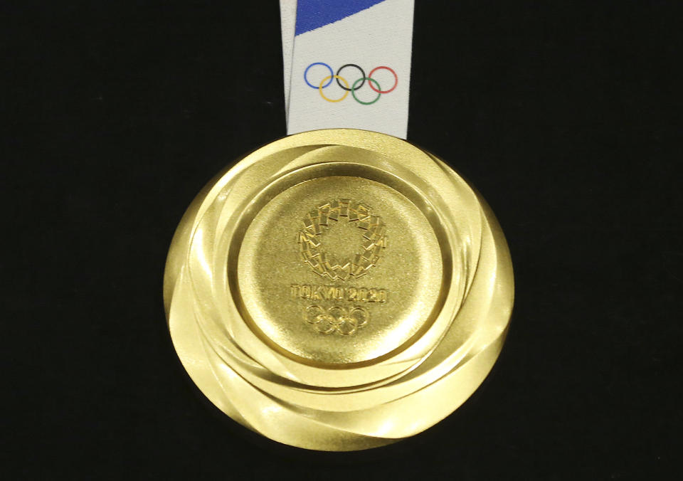 Tokyo 2020 Olympic gold medal is unveiled during a One Year to Go Olympic ceremony event in Tokyo Wednesday, July 24, 2019. Gold, silver, and bronze Olympic medals were to get their first public viewing on Wednesday as Tokyo organizers marked exactly a year until the games open. (AP Photo/Koji Sasahara)