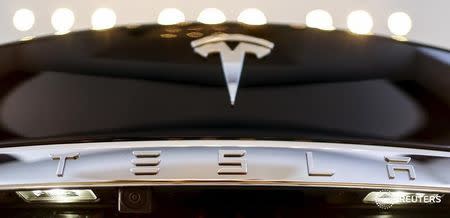 A Tesla logo adorns a 'Model S' car in the dealership in Berlin, Germany, November 18, 2015. REUTERS/Hannibal Hanschke