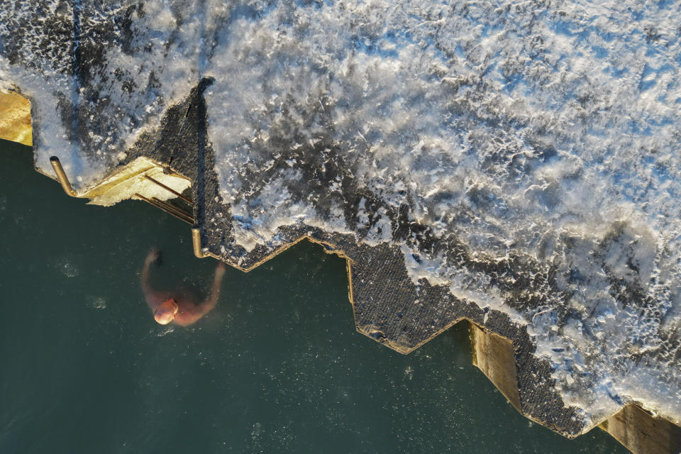 George Miller climbs out of the icy waters of Lake Michigan, Thursday, Feb. 2, 2023, in Chicago. (AP Photo/Erin Hooley)