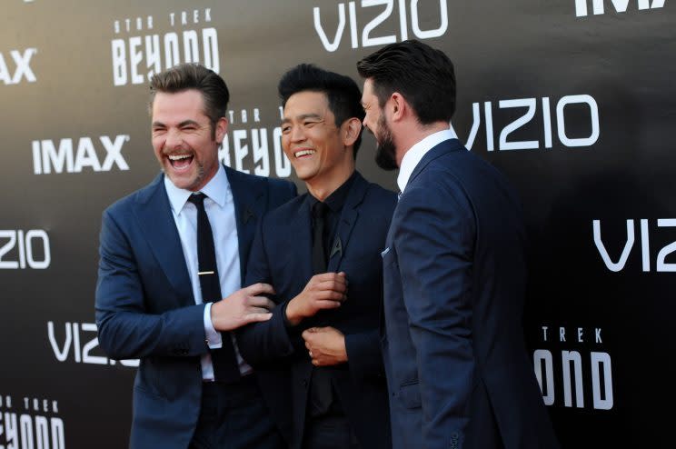  Chris Pine, John Cho, and Karl Urban laughing on the red carpet. 