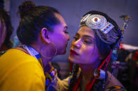 Dione, left, and Mayumi wish each others before the start of the Miss Trans Northeast 22, beauty pageant in Guwahati, India, Wednesday, Nov. 30, 2022. In a celebration of gender diversity and creative expression, a beauty pageant in eastern Indian state of Assam brought dozens of transgender models on stage in Guwahati. Sexual minorities across India have gained a degree of acceptance especially in big cities and transgender people were given equal rights as a third gender in 2014. But prejudice against them persists and the community continues to face discrimination and rejection by their families. (AP Photo/Anupam Nath)