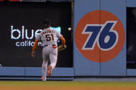 San Francisco Giants right fielder Luis Gonzalez chases a ball which landed for a two-run double by Los Angeles Dodgers' Justin Turner during the third inning of a baseball game Thursday, July 21, 2022, in Los Angeles. (AP Photo/Marcio Jose Sanchez)