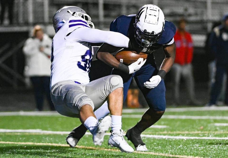 Bloomington South’s Noah Fox (90) tackles N’Po Dodo (11) for a loss during the IHSAA 5A semistate football game at Decatur Central on Friday, Nov. 17, 2023.