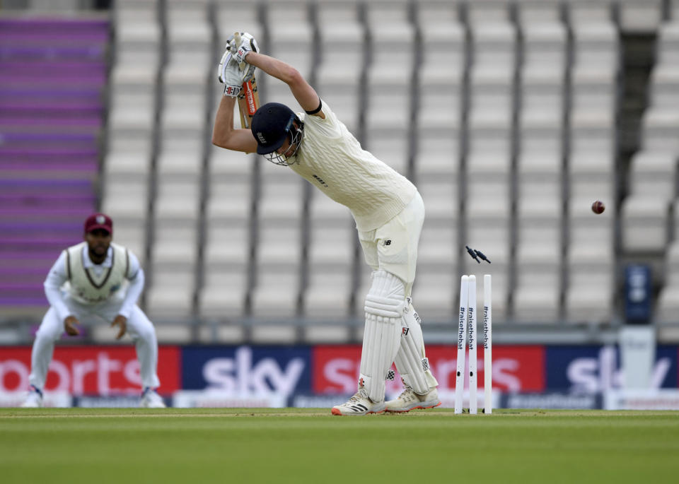 England's Dom Sibley is bowled out on the first day of the 1st cricket Test match between England and West Indies, at the Ageas Bowl in Southampton, England, Wednesday July 8, 2020. (Mike Hewitt/Pool via AP)