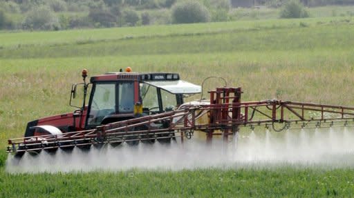 Photo illustration shows a farmer treating a field in france. By 2050, the world's population was expected to rise by a third, from 6.9 billion today to 9.1 billion. Demand for food would rise even higher, by 70 percent, as more prosperous economies demanded more calories