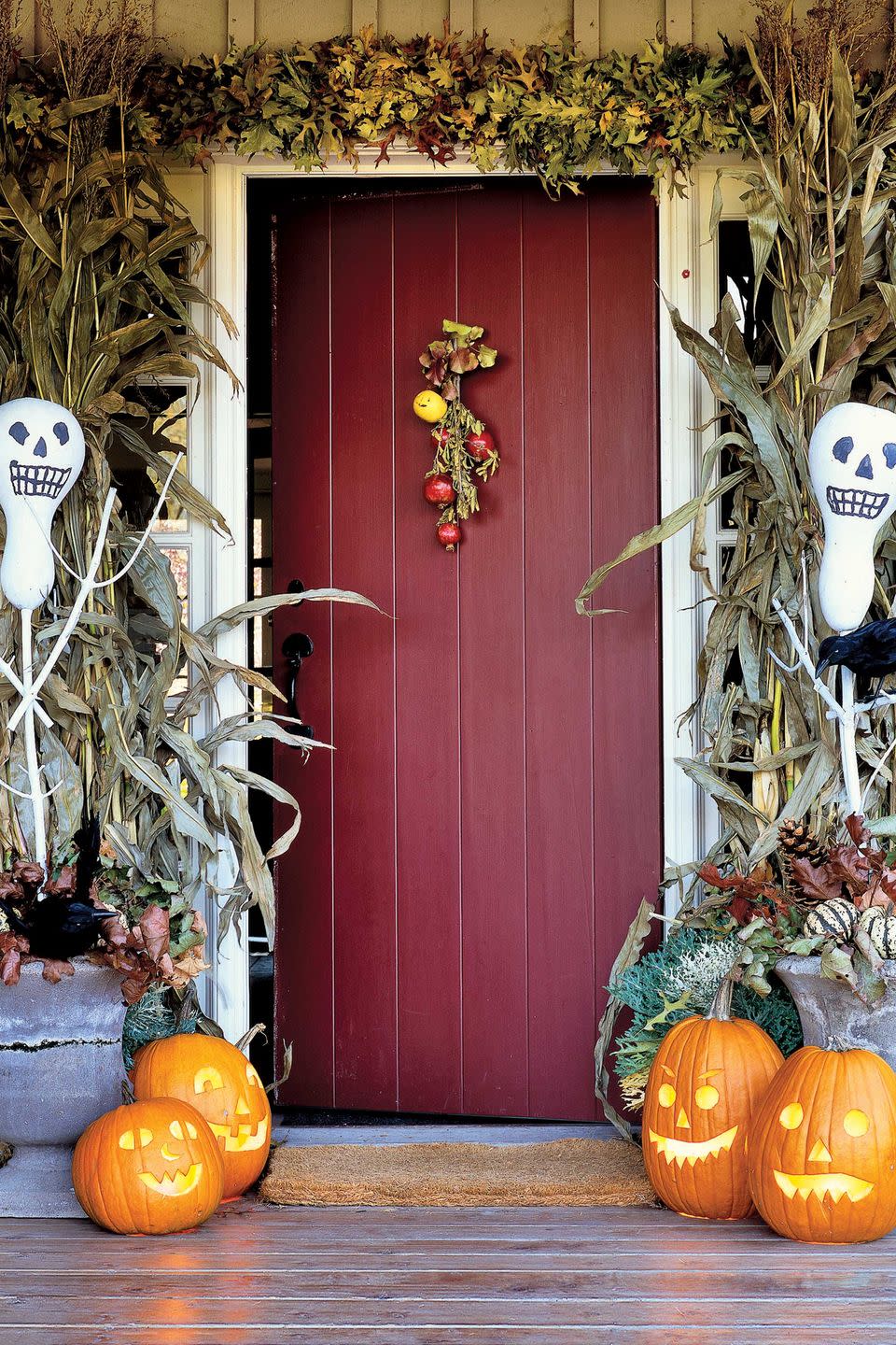 <p>Give trick-or-treaters and guests a festive first impression, framing the front door with these skeletal gourds. These bottle-gourd scarecrows were painted white, with features added in black felt tip pen. Just spear them on sticks and "plant" them in Styrofoam blocks inside urns to create a festive welcome to your Halloween home. </p>