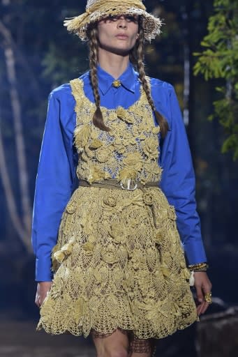 A model in Greta Thunberg-style plaits and an eco-friendly raffia dress during Dior's Paris women's fashion week show in September