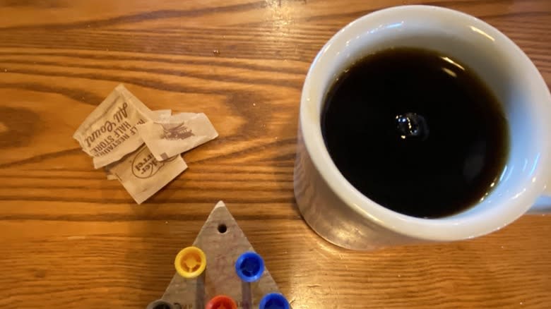 Cracker Barrel coffee on table next to peg game