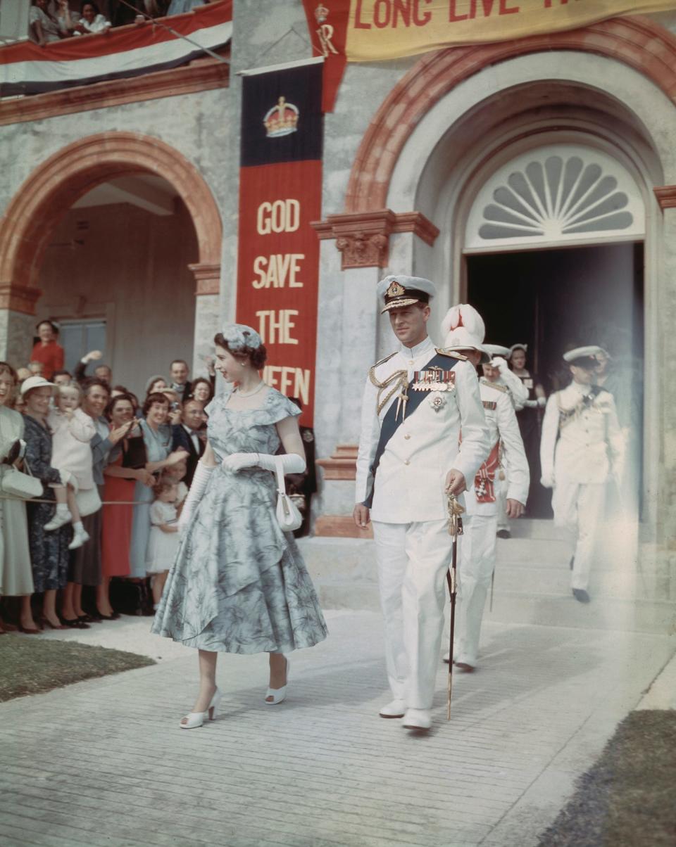 Queen Elizabeth II and Prince Philip, Duke of Edinburgh leave the House of Assembly in Hamilton, Bermuda, during a six-month tour of the Commonwealth nations, November 1953.