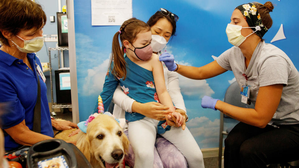 Six-year-old Clara Bengle sits on her mother's lap ready for a Pfizer-BioNTech coronavirus vaccine at a vaccination clinic in San Diego on Nov.