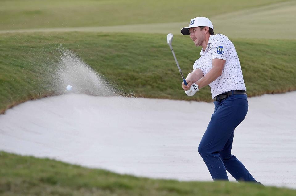 Mackenzie Hughes blasts out of the sand on the 18th green during the first of two playoff holes on the final day of the Sanderson Farms Championship at the Country Club of Jackson on Sunday, October 2, 2022, in Jackson, Miss. Hughes would save his par and win on the second playoff hole with a birdie. 