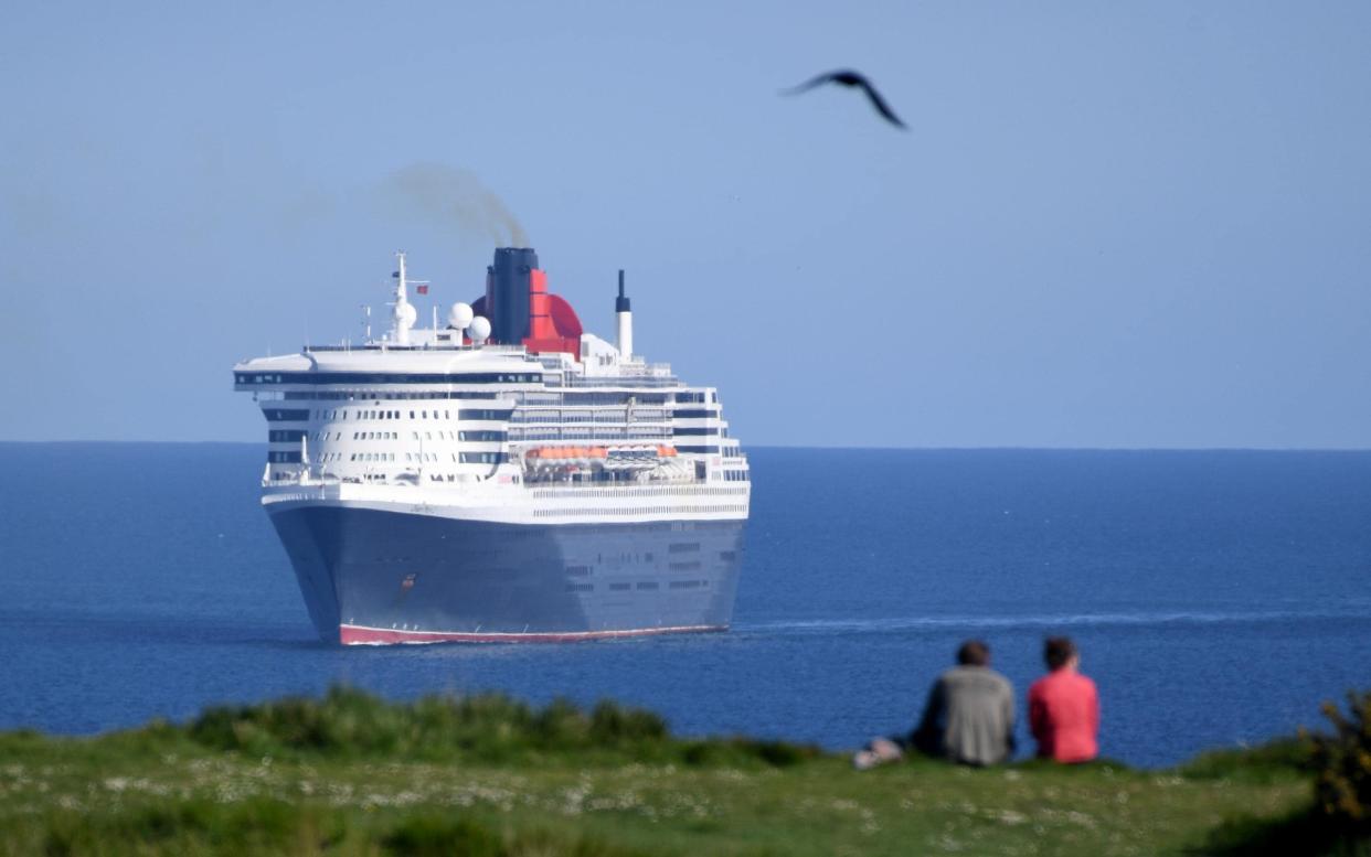 Queen Mary 2 anchored off the coast of Dorset - getty