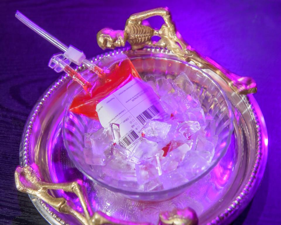 A blood bag cocktail known as a B Positive (blood orange and vodka) chills on ice at Kelleher's Irish Pub's Cauldrons and Cocktails Halloween-themed pop-up bar in Peoria.