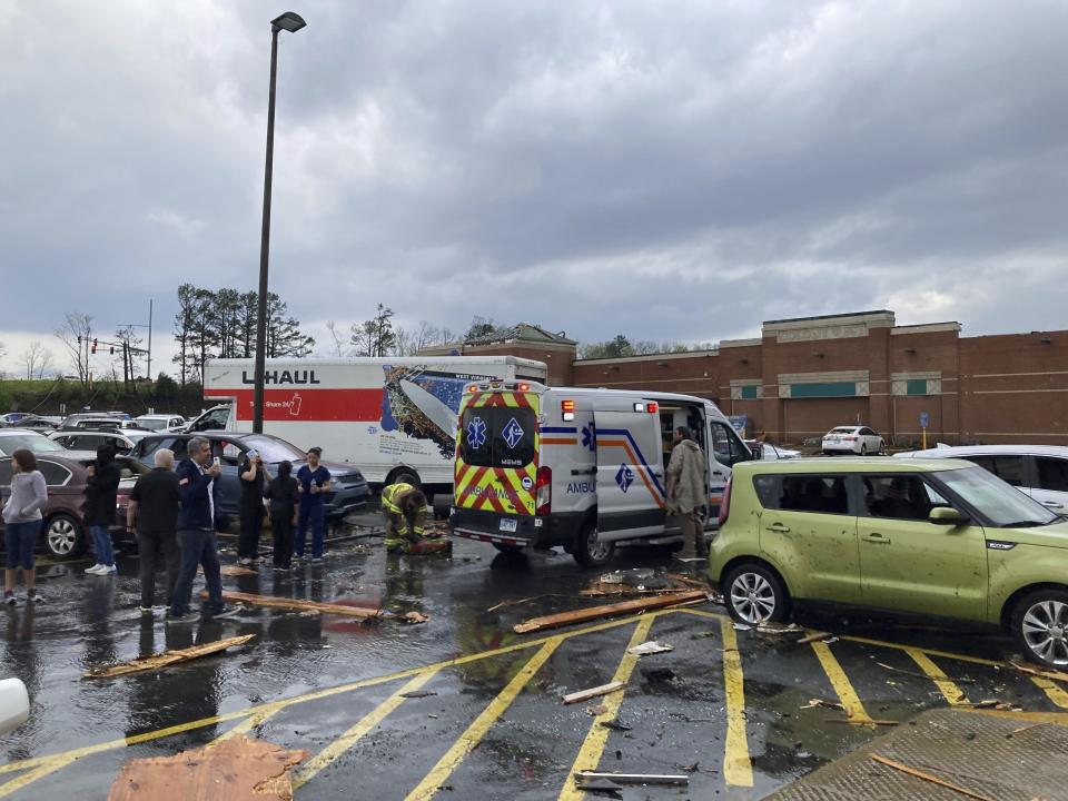 Emergency personnel check people in a parking lot after severe storm swept through Little Rock, Ark., Friday, March 31, 2023. (AP Photo/Andrew DeMillo)