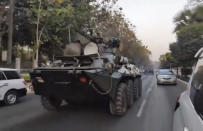 In this image made from video by the Democratic Voice of Burma (DVB), two armored personnel carriers were seen traversing on a road in Yangon, Myanmar, Sunday, Feb. 14, 2021. Sightings of armored personnel carriers in Myanmar’s biggest city and an internet shutdown raised political tensions late Sunday, after vast numbers of people around the country flouted orders against demonstrations to protest the military’s seizure of power. (DVB via AP)