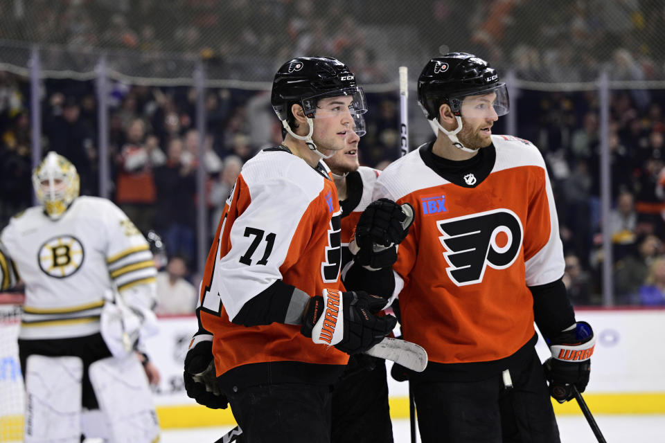 Philadelphia Flyers' Tyson Foerster (71) celebrates his goal with Olle Lycksell and Sean Couturier, right, during the second period of an NHL hockey game against the Boston Bruins, Saturday, Jan. 27, 2024, in Philadelphia. (AP Photo/Derik Hamilton)