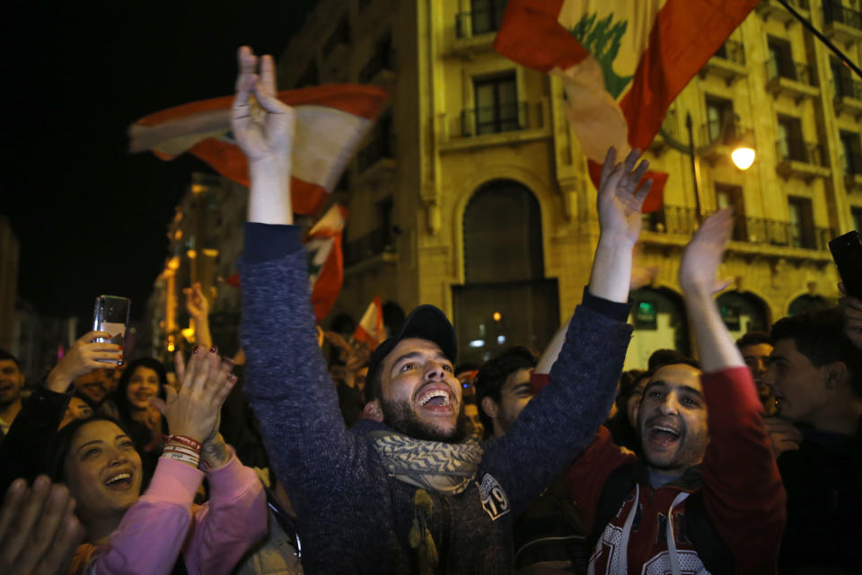 Anti-government demonstrators chant slogans during a protest on a road leading to the parliament building in Beirut, Lebanon, Thursday, Jan. 16, 2020. Lebanese protesters Thursday decried security forces' use of violence during rallies over the past two days, including attacks on journalists and the detention of over 100 people. (AP Photo/Bilal Hussein)