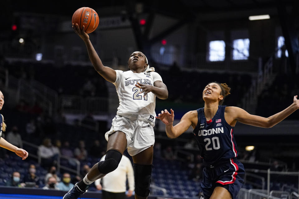 Butler guard Upe Atosu (21) shoots in front of Connecticut forward Olivia Nelson-Ododa (20) during the third quarter of an NCAA college basketball game in Indianapolis, Saturday, Feb. 27, 2021. (AP Photo/Michael Conroy)