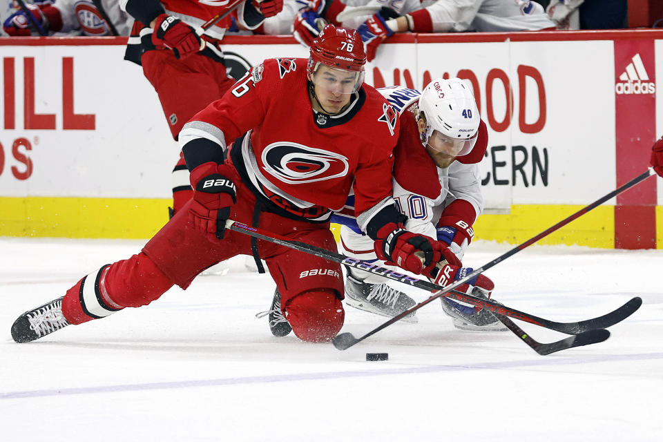 Carolina Hurricanes' Brady Skjei (76) battles for the puck with Montreal Canadiens' Joel Armia (40) during the first period of an NHL hockey game in Raleigh, N.C., Thursday, Feb. 16, 2023. (AP Photo/Karl B DeBlaker)