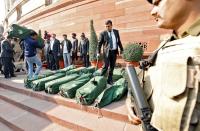 A security force personnel scans bags containing budget papers inside the Parliament premises in New Delhi