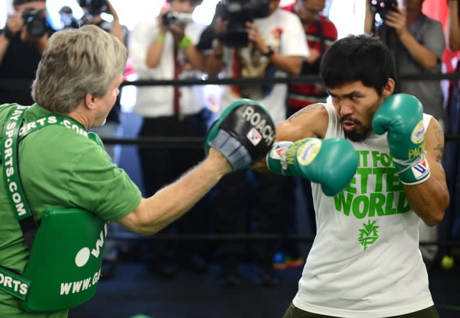 Freddie Roach (L) And Manny Pacquiao (R) Of The Philippines Take A Media Workout At Wild Card Boxing Club On May 30,  AFP/Getty Images