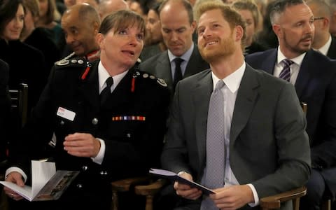 Prince Harry sits next to London Fire Brigade Commissioner Dany Cotton at the London Fire Brigade carol service in 2017 - Credit: Getty