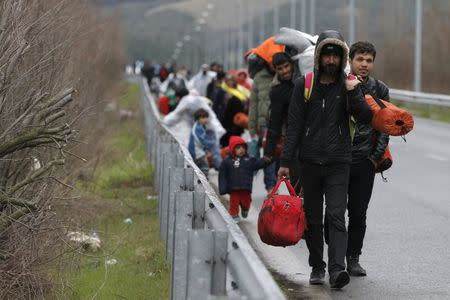 Migrants walk along a road towards a makeshift camp at the Greek-Macedonian border, near the Greek village of Idomeni, Greece March 4, 2016. REUTERS/Marko Djurica