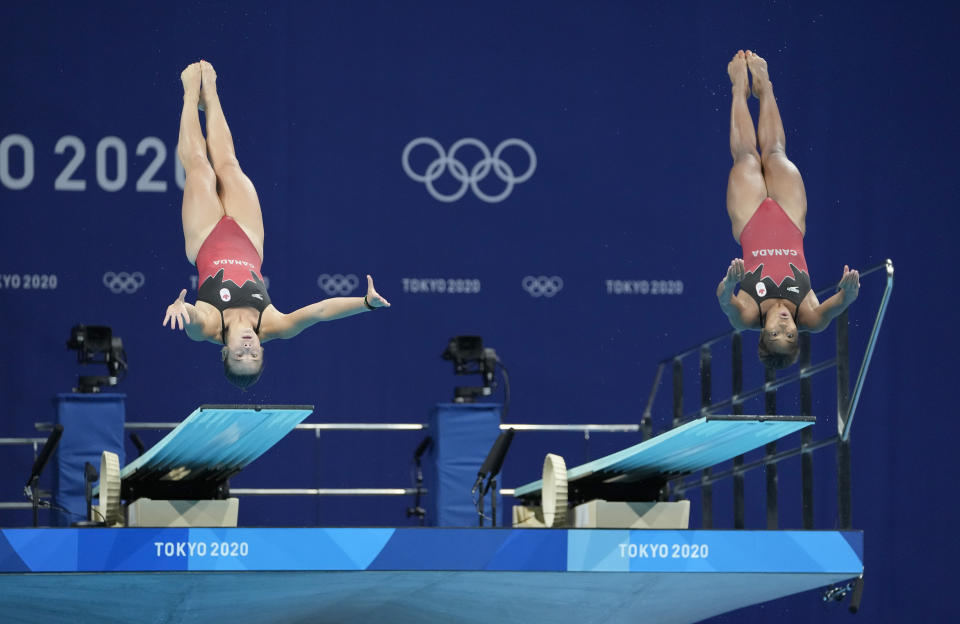 Jennifer Abel and Melissa Citrini Beaulieu of Canada compete during the Women's Synchronized 3m Springboard Final at the Tokyo Aquatics Centre at the 2020 Summer Olympics, Sunday, July 25, 2021, in Tokyo, Japan. (AP Photo/Dmitri Lovetsky)