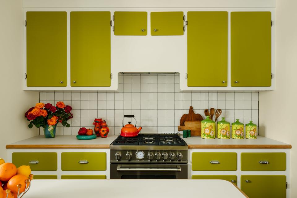 The kitchen is the only space where you’ll find white walls, but the pastel-adjacent cabinets offer plenty of personality.