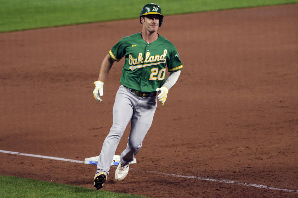 Oakland Athletics' Mark Canha advances to third base on a passed ball during the third inning of a baseball game against the Kansas City Royals, Tuesday, Sept. 14, 2021 in Kansas City, Mo. (AP Photo/Reed Hoffmann)