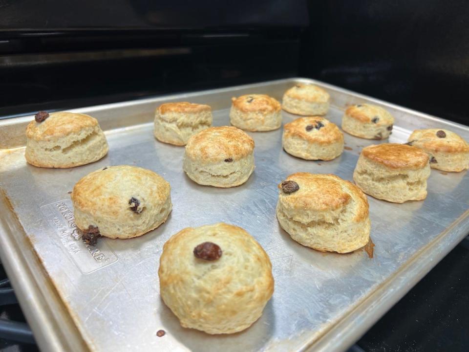 A photo shows baked scones on a baking tray.