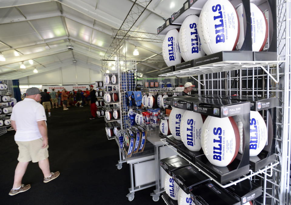 FILE - In this July 27, 2017, file photo, fans shop in the merchandise tent on opening day of Buffalo Bills NFL football training camp in Pittsford, N.Y. The Mafia is becoming legitimate in Buffalo — the Bills Mafia that is. The Bills last week filed an application to trademark its fanbase’s adopted nickname in preparation to launch a series of branded merchandise and apparel available at its team store and sold online. (AP Photo/Adrian Kraus, File)