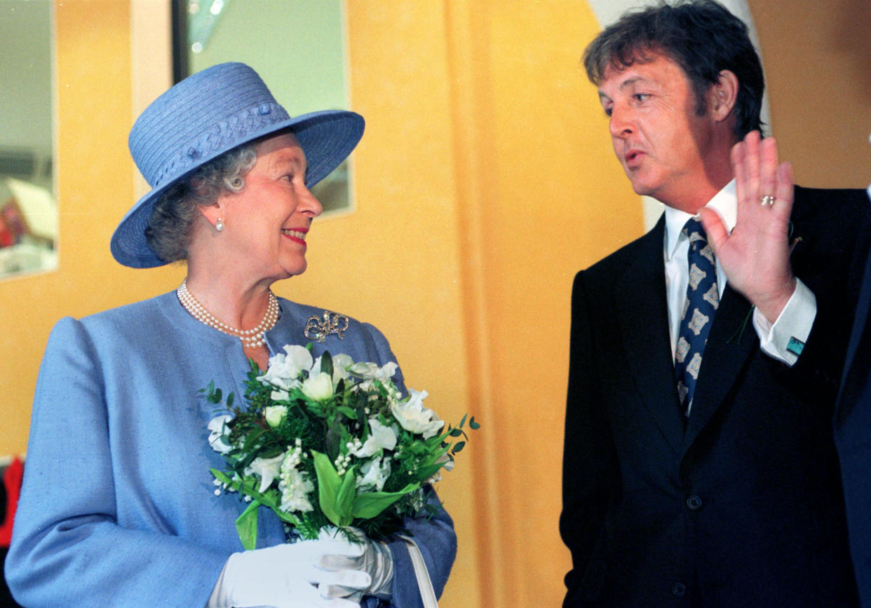 Paul McCartney chats with Queen Elizabeth II. (Photo: Reuters)