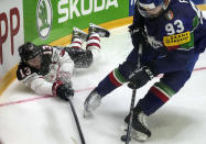 Matt Barzal of Canada, left, is challenged by Italy's Luca Frigo during the group A Hockey World Championship match between Italy and Canada in Helsinki, Finland, Sunday May 15, 2022. (AP Photo/Martin Meissner)