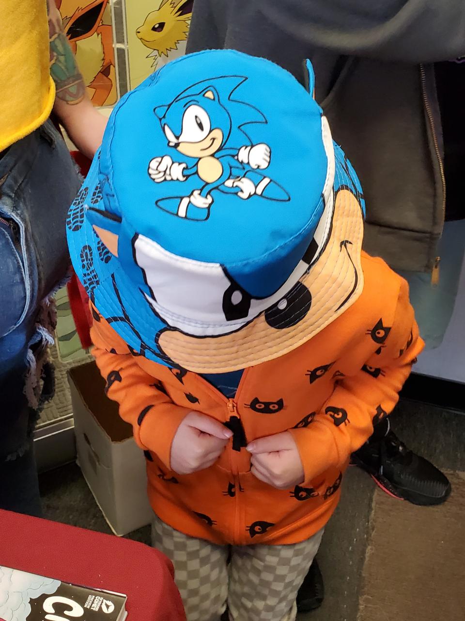 Matilda Clark, 5, of York, skillfully hides under her Sonic the Hedgehog hat during Free Comic Book Day in Rochester Saturday, May 7, 2022.