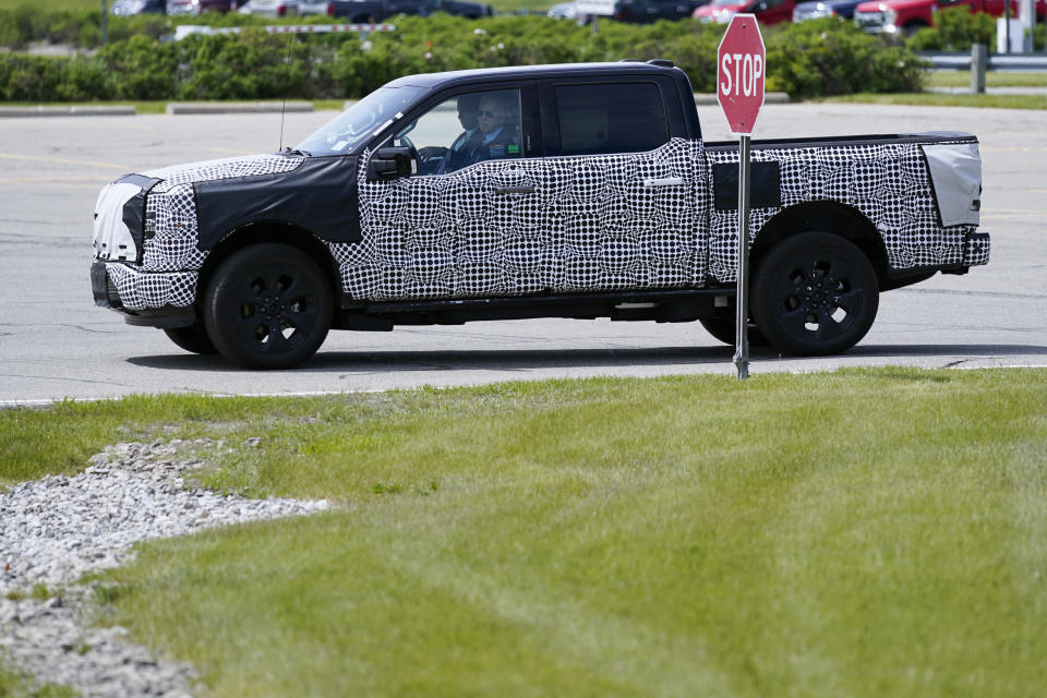 President Joe Biden drives a Ford F-150 Lightning truck at Ford Dearborn Development Center, Tuesday, May 18, 2021, in Dearborn, Mich. (AP Photo/Evan Vucci)