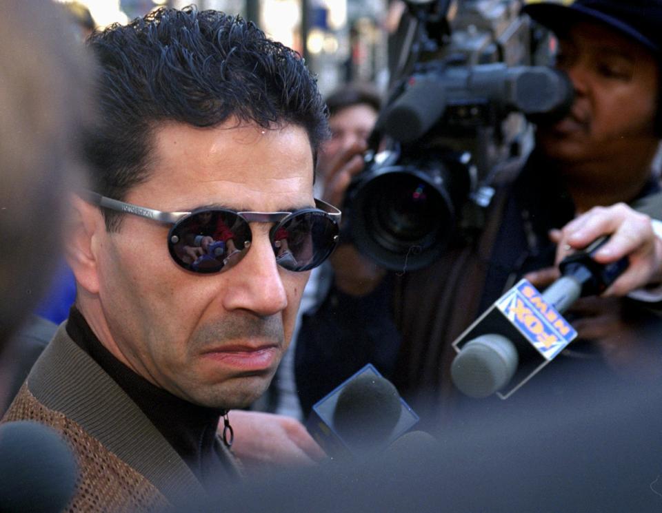 FILE - In this Feb. 20, 1997 file photo, Joseph "Skinny Joey" Merlino talks to the media outside the Criminal Justice Center in Philadelphia. On Friday, Nov. 20, 2020, The Associated Press reported on stories circulating online incorrectly claiming the campaign for President-elect Joe Biden paid Merlino, who was once a mob boss in Philadelphia, to fill out 300,000 blank ballots. (AP Photo/ H. Rumph, Jr., File)