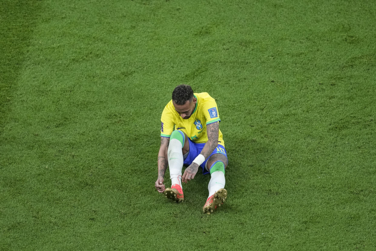 Brazil's Neymar, lies on the pitch during the World Cup group G soccer match between Brazil and Serbia, at the the Lusail Stadium in Lusail, Qatar on Thursday, Nov. 24, 2022. (AP Photo/Darko Vojinovic)