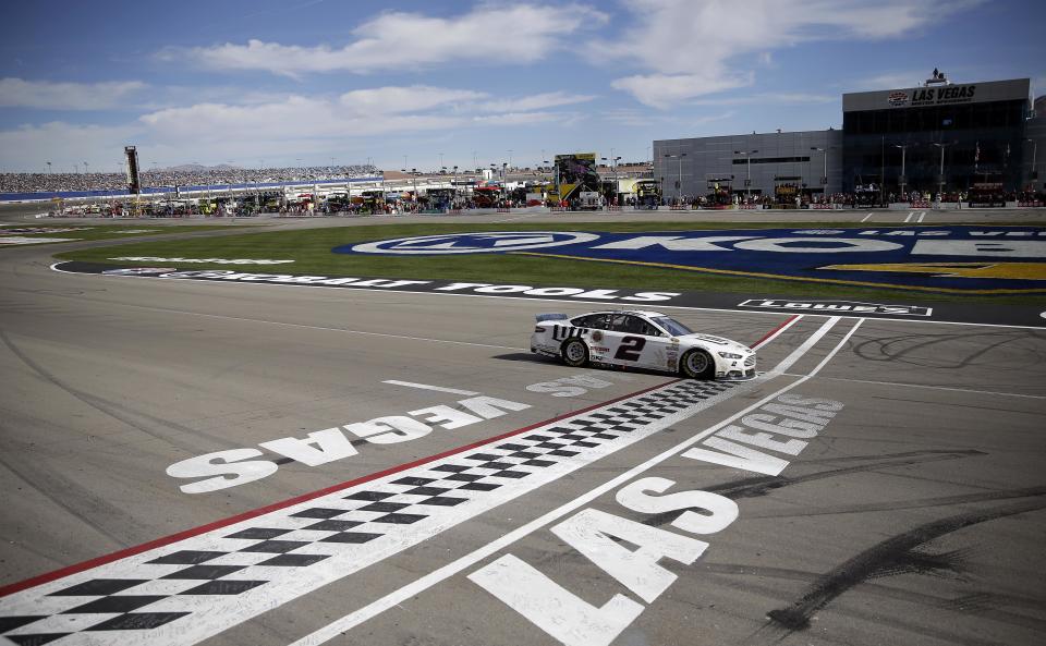 Brad Keselowski (2) passes the finish line to win a NASCAR Sprint Cup Series auto race Sunday, March 9, 2014, in Las Vegas. (AP Photo/Isaac Brekken)