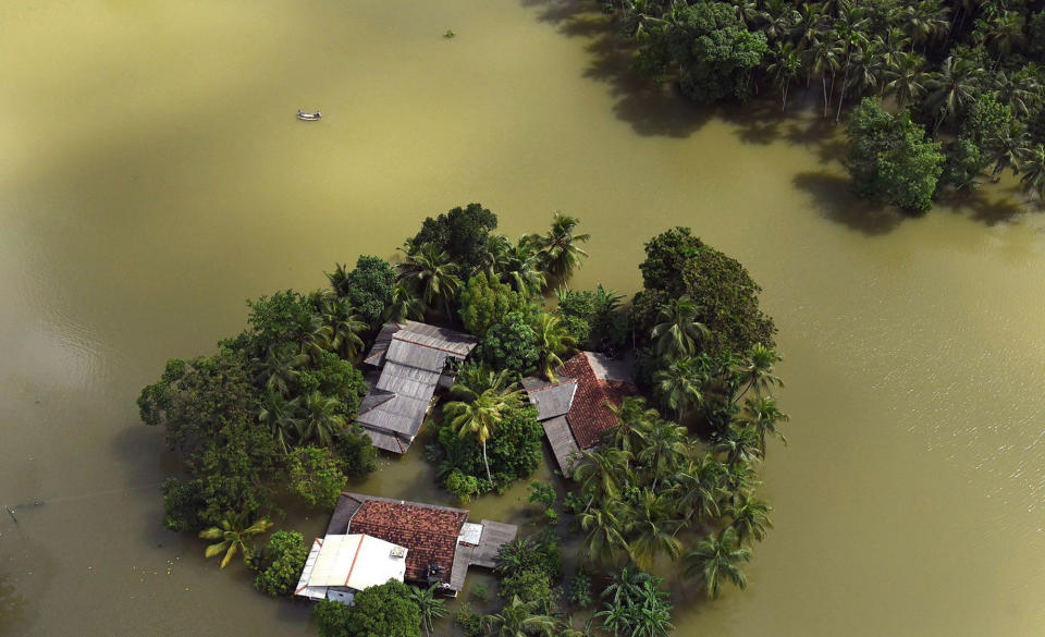 <p>Houses are submerged in floodwaters in Sri Lanka. Helicopters searched for people still marooned after rain-triggered floods and mudslides inundated villages 28, 2017 (Sri Lanka Air Force via AP) </p>