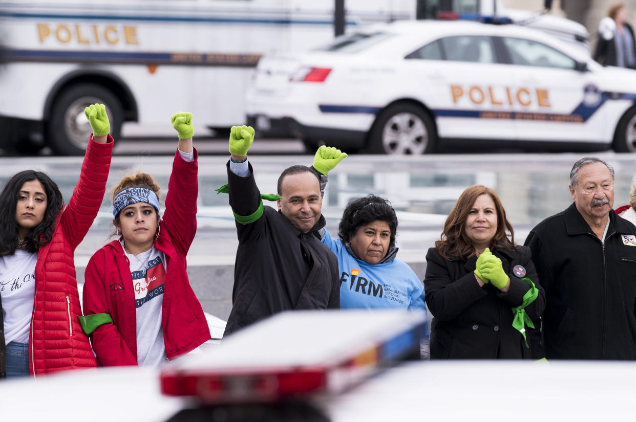 Immigration protesters, including Rep. Luis&nbsp;Guti&eacute;rrez (center), stand in a line after being arrested at the U.S. Capitol on Dec. 6. (Photo: Bill Clark via Getty Images)