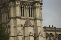 Technicians work on top of the Notre Dame cathedral in Paris, Monday, April 22, 2019. In the wake of the fire last week that gutted Notre Dame, questions are being raised about the state of thousands of other cathedrals, palaces and village spires that have turned France — as well as Italy, Britain and Spain — into open air museums of Western civilization. (AP Photo/Francisco Seco)