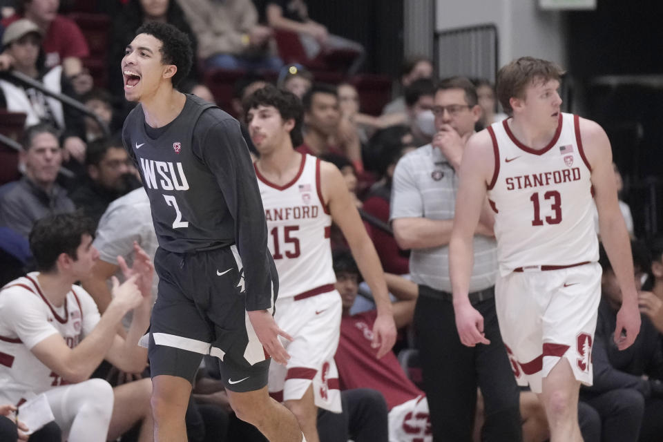 Washington State guard Myles Rice (2) reacts after making a 3-point basket, next to Stanford guard Benny Gealer (15), coach Jerod Haase, second from right, and guard Michael Jones (13) during the first half of an NCAA college basketball game in Stanford, Calif., Thursday, Jan. 18, 2024. (AP Photo/Jeff Chiu)