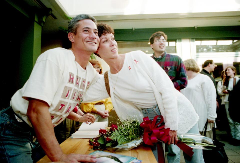 Olympic diver Greg Louganis, left, poses with fan Rita Underwood at Davis-Kidd Booksellers in Green Hills April 6, 1995. More than 1,100 showed up for the signing of his book, "Breaking the Surface."