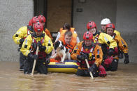 Members of the emergency services evacuate local residents from a flooded area in Brechin, Scotland, Friday Oct. 20, 2023. The gale-force winds are expected to hit hardest the eastern part of Denmark's Jutland peninsula and the Danish islands in the Baltic Sea. But the British Isles, southern Sweden, northern Germany and parts of Norway also on the path of the storm, named Babet by U.K.’s weather forecaster, the Met Office. (Andrew Milligan/PA Wire/PA via AP)